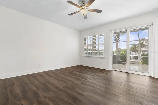 a bathroom with a granite countertop toilet a sink and a window