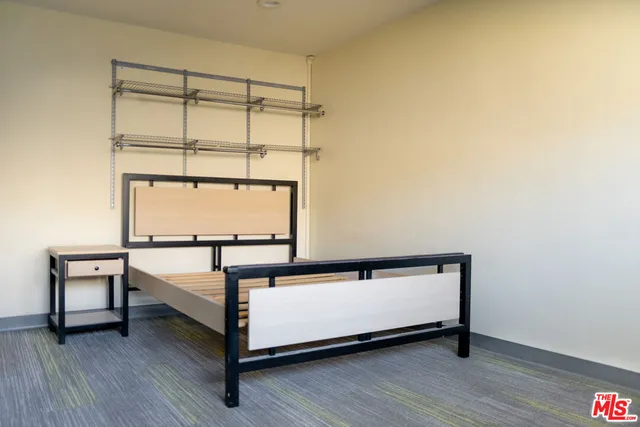 a view of a room with wooden floor and small window
