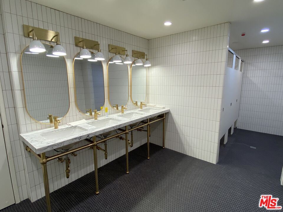 920 West 28th Street Los Angeles, CA 90007 - Photo 6 of 7 a bathroom with a double vanity sink and a mirror