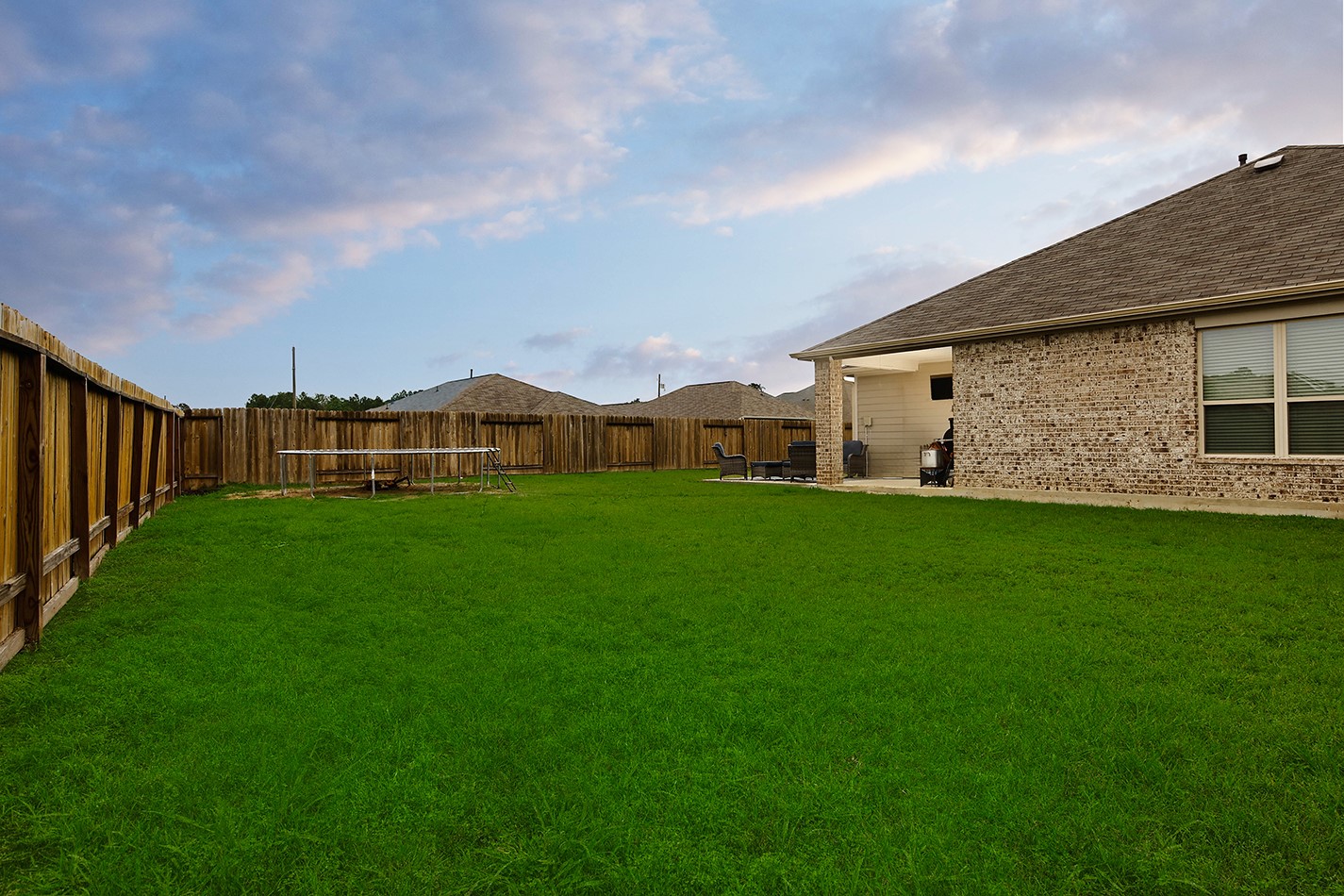 26324 Cooperstown Way Splendora, TX 77372 - Photo 22 of 23 a view of a house with a big yard potted plants and large tree
