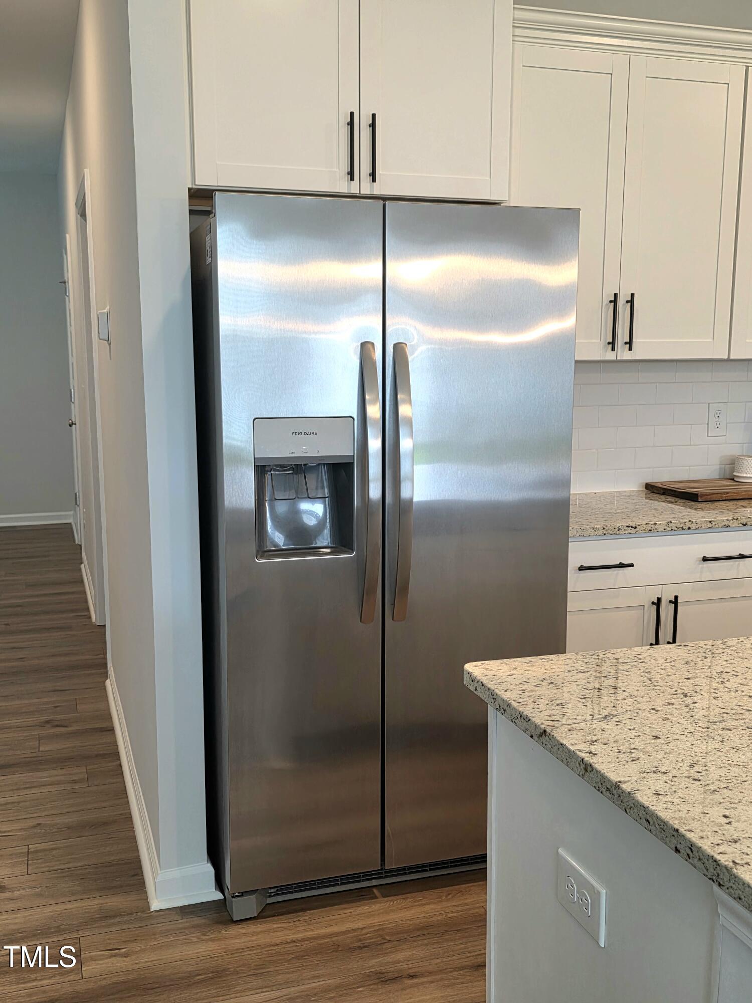 27 Nettle Lane Clayton, NC 27520 - Photo 12 of 37 a kitchen with granite countertop stainless steel appliances and refrigerator