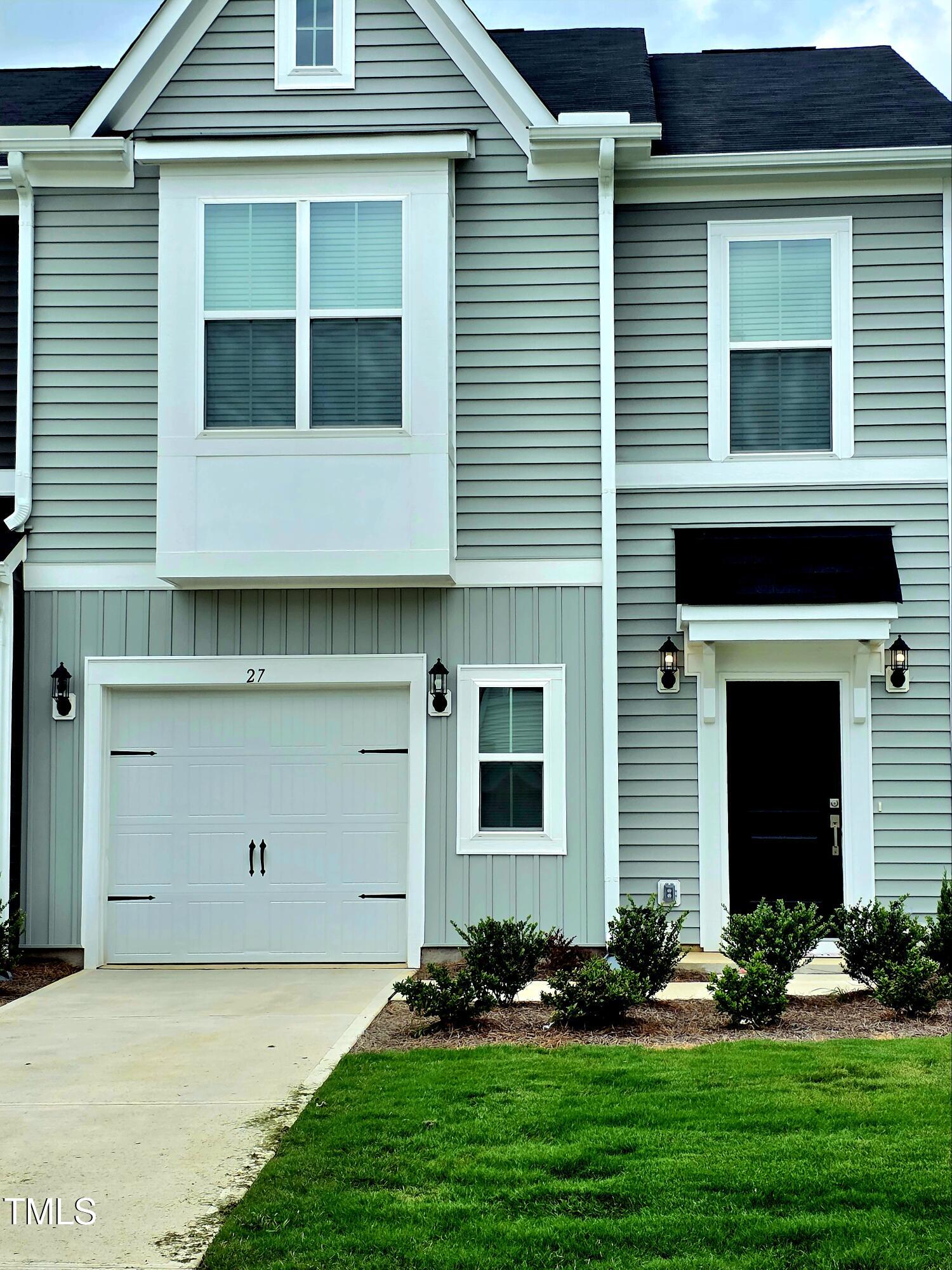 27 Nettle Lane Clayton, NC 27520 - Photo 2 of 37 a front view of a house with garden