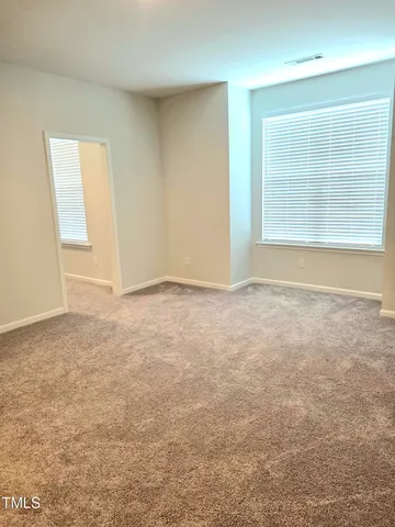 a spacious bathroom with a double vanity sink a mirror and a bathtub