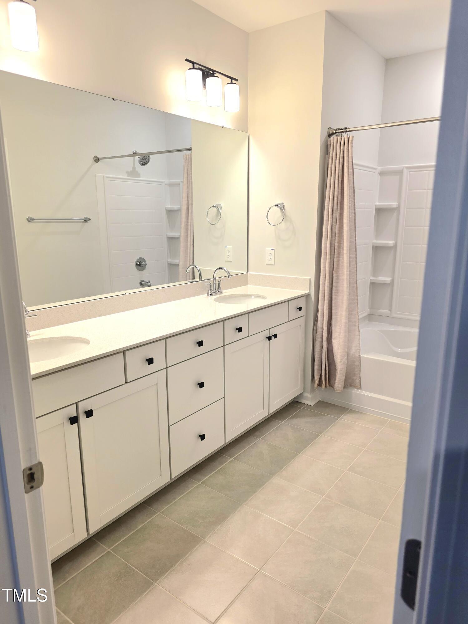 27 Nettle Lane Clayton, NC 27520 - Photo 24 of 37 a spacious bathroom with a double vanity sink a large mirror and shower