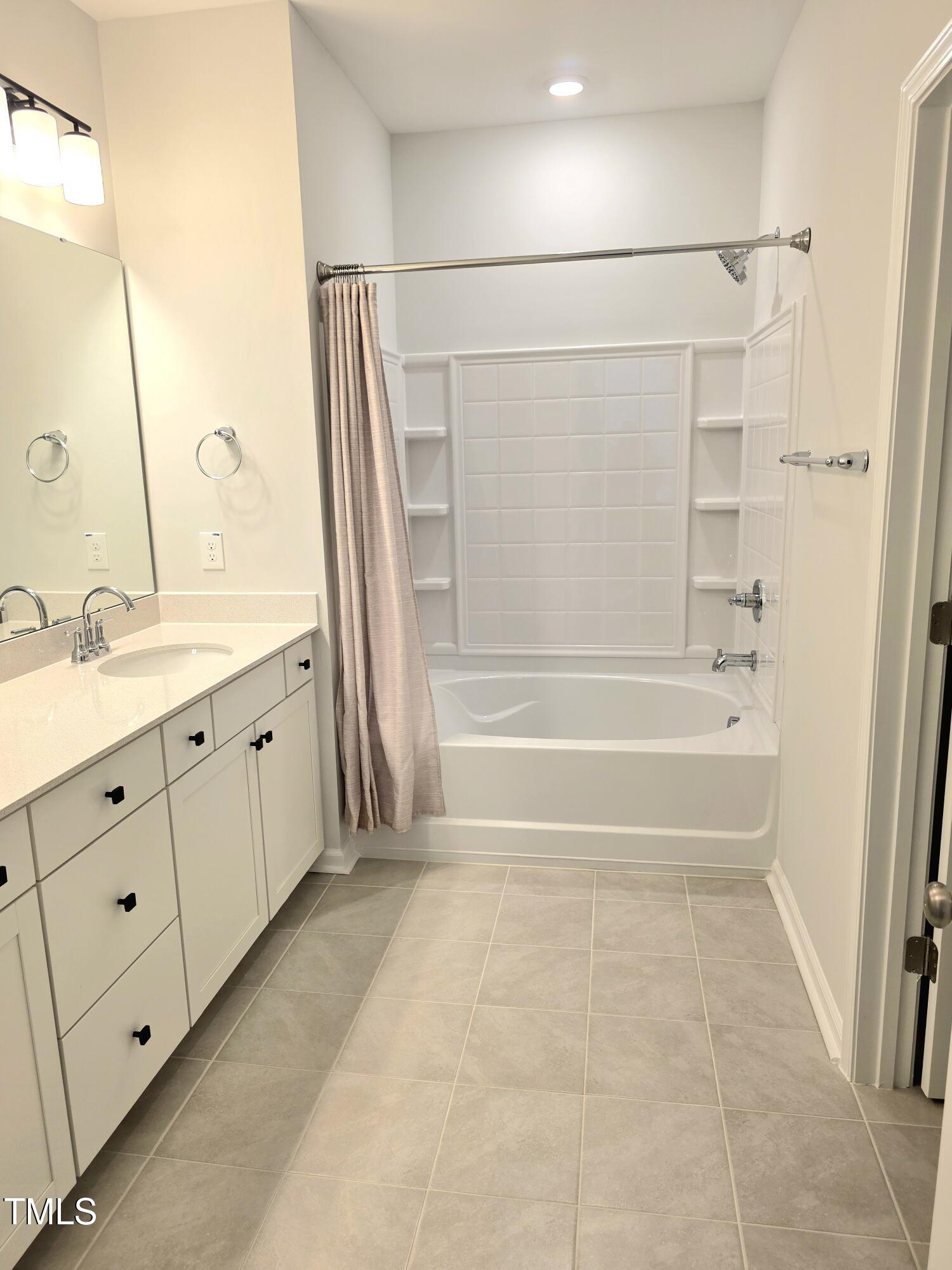 27 Nettle Lane Clayton, NC 27520 - Photo 25 of 37 a spacious bathroom with a double vanity sink a mirror and a bathtub