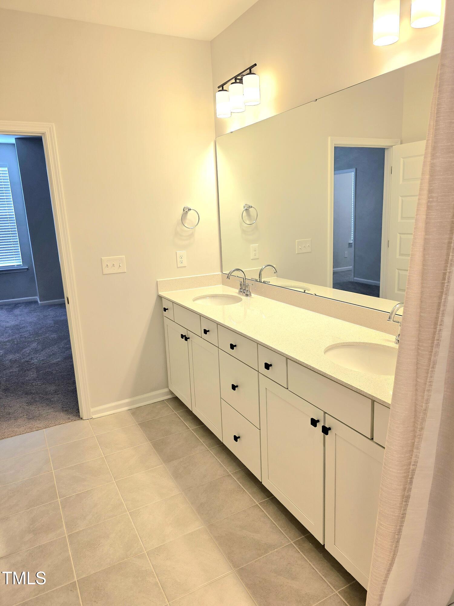 27 Nettle Lane Clayton, NC 27520 - Photo 26 of 37 a bathroom with a granite countertop sink and a mirror