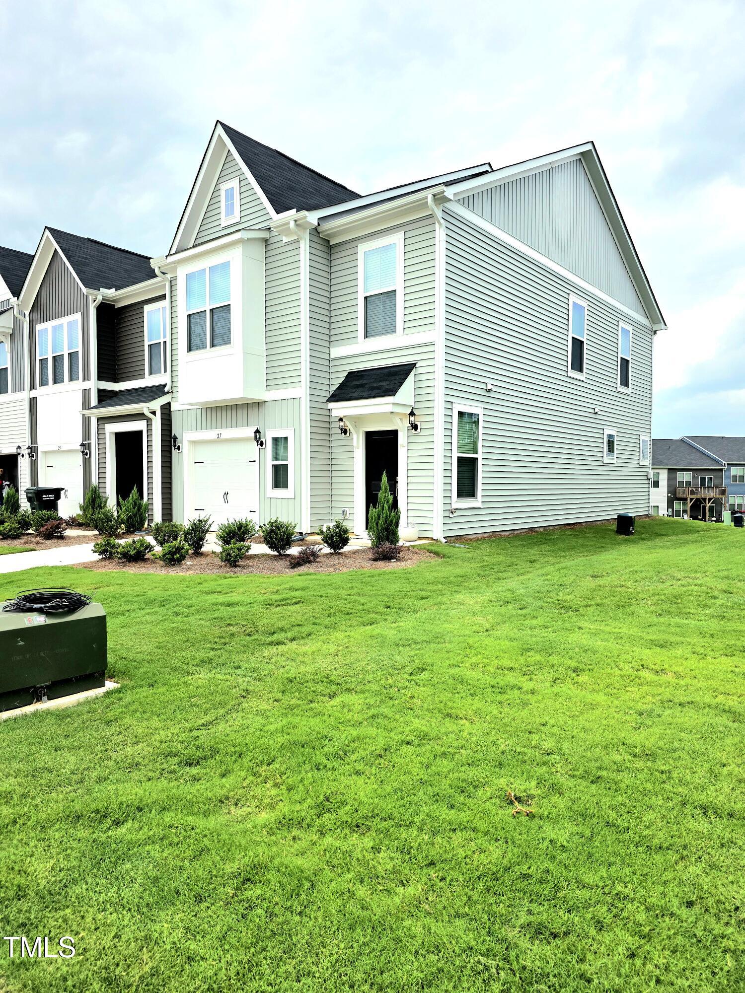 27 Nettle Lane Clayton, NC 27520 - Photo 3 of 37 a front view of a house with a yard and garage