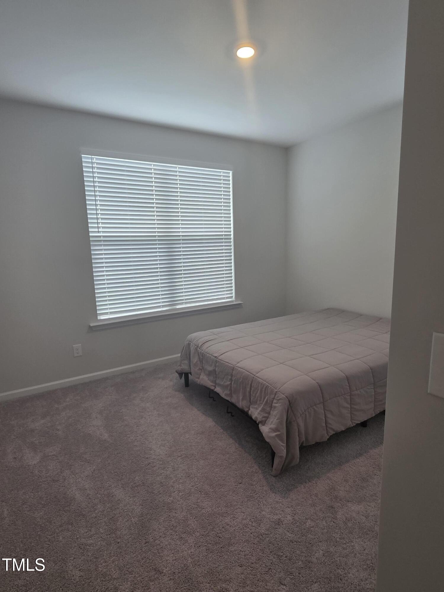 27 Nettle Lane Clayton, NC 27520 - Photo 32 of 37 a spacious bedroom with a bed and a window