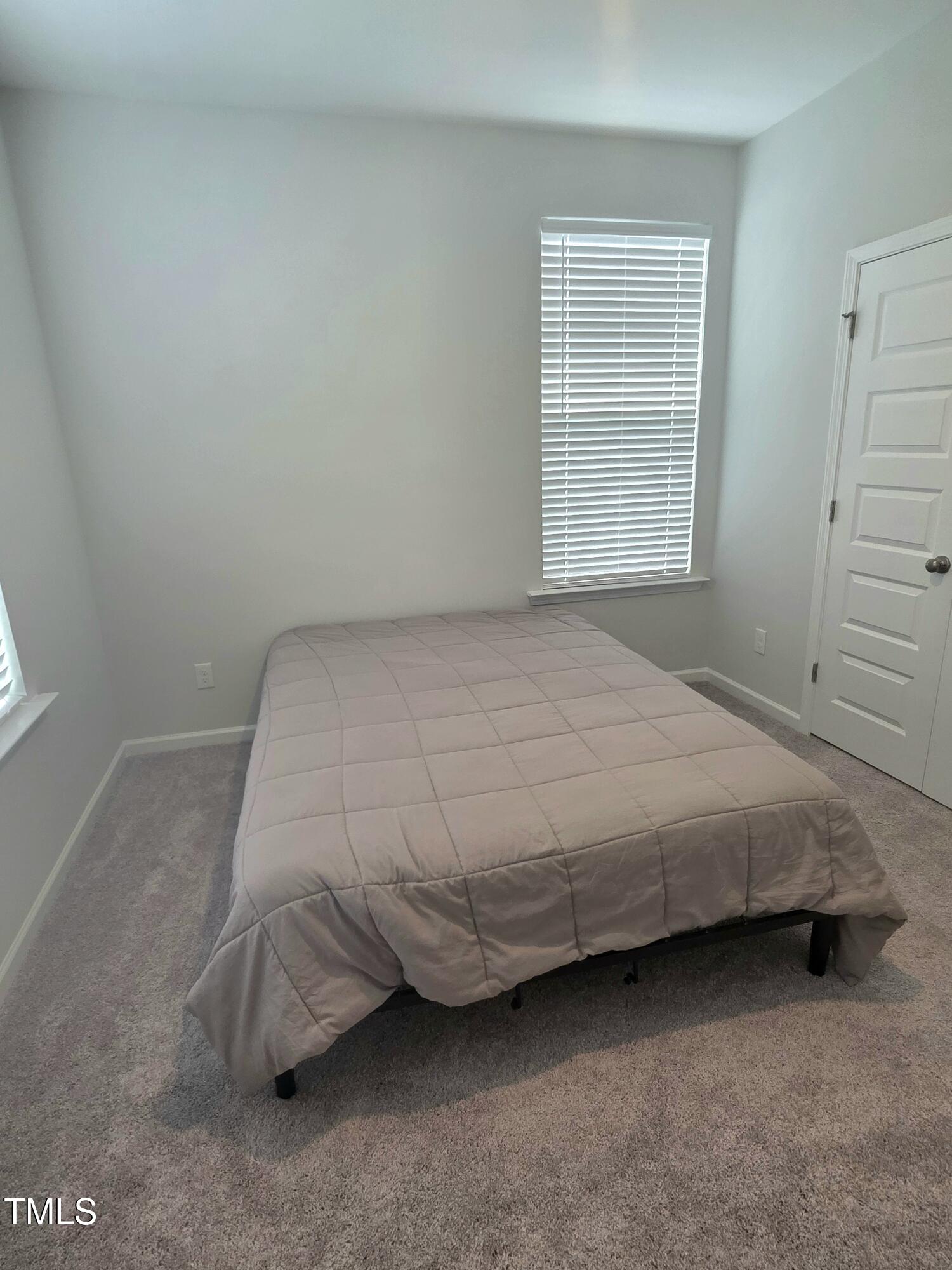 27 Nettle Lane Clayton, NC 27520 - Photo 33 of 37 a bedroom with a bed and a window