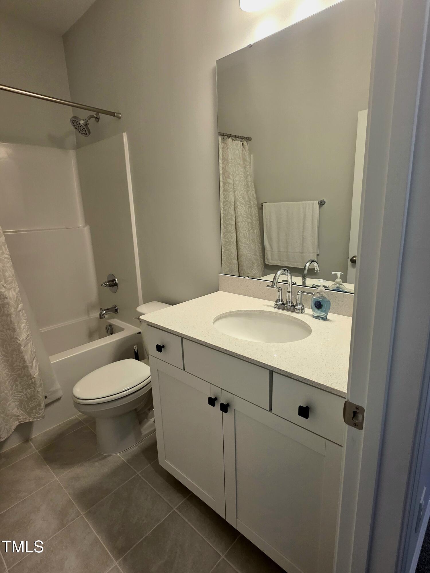 27 Nettle Lane Clayton, NC 27520 - Photo 35 of 37 a bathroom with a sink a toilet and mirror