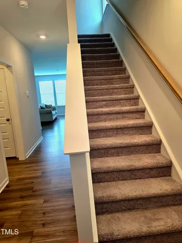 a view of entryway and hall with wooden floor