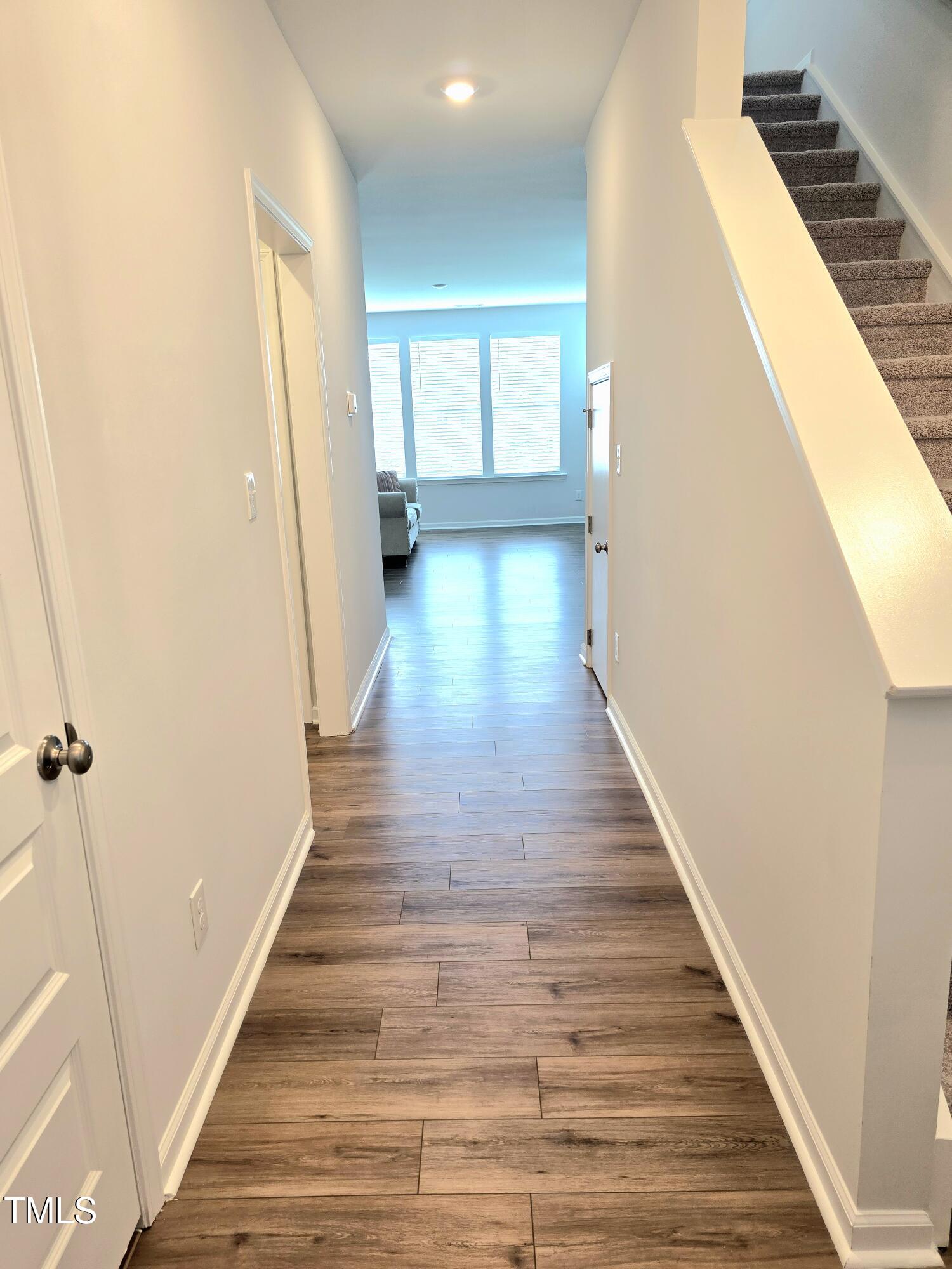 27 Nettle Lane Clayton, NC 27520 - Photo 5 of 37 a view of a hallway with wooden floor and staircase