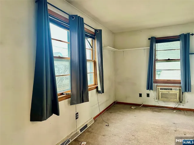 a room with a dresser and a window