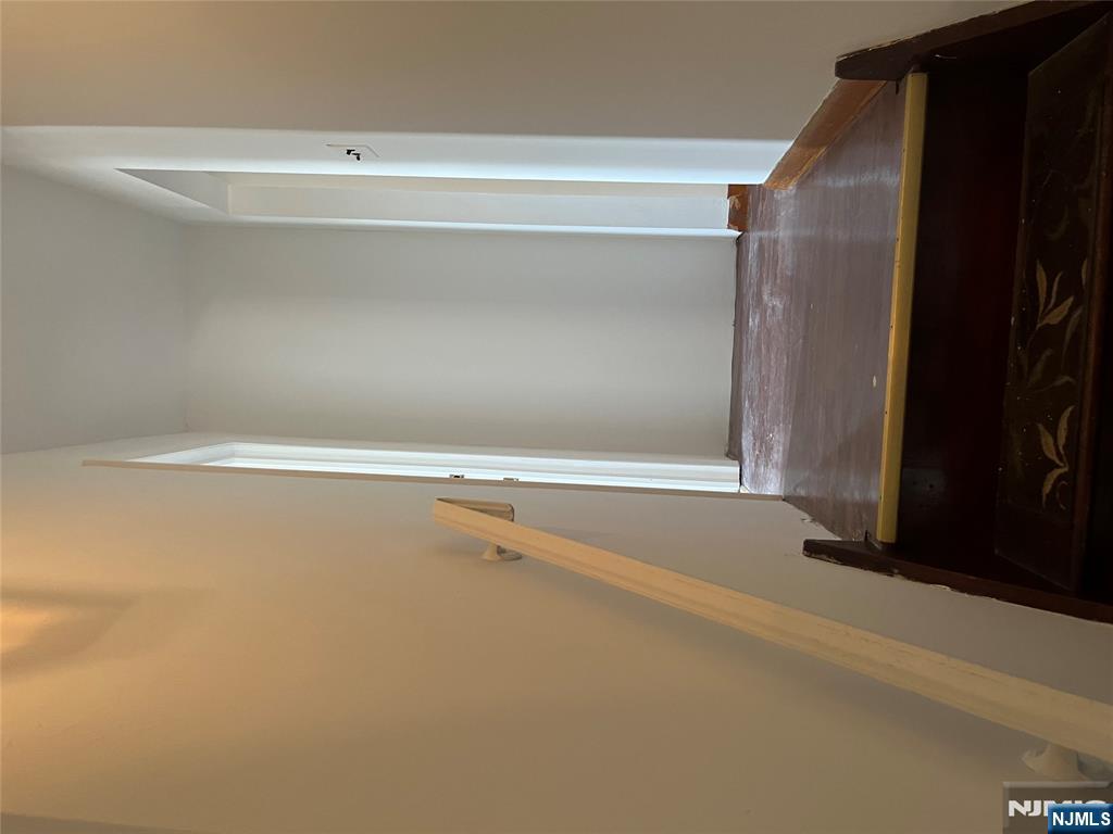 70 Orchard Street Garfield, NJ 07026 - Photo 16 of 17 a view of room with stairs and a rug