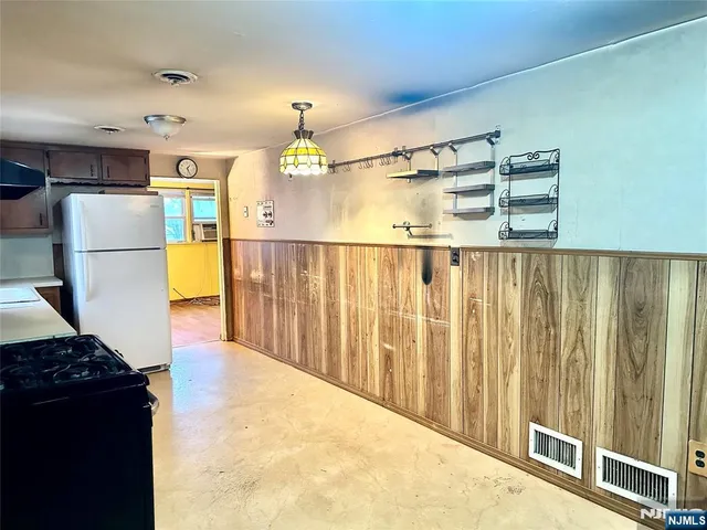 a view of kitchen with furniture and a refrigerator