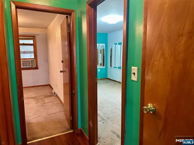 view of a bathroom with a shower and a door