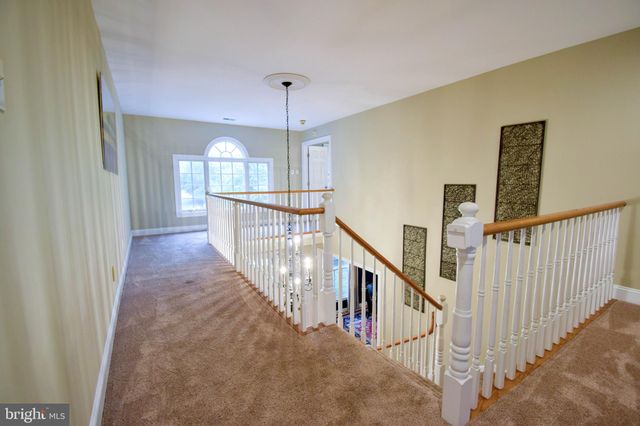 a bedroom with bed and a chandelier