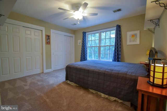 a bathroom with a sink a toilet a shower and a window