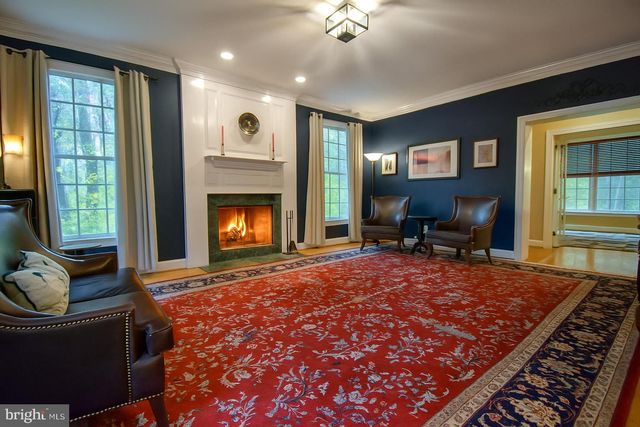 a living room with furniture rug and window