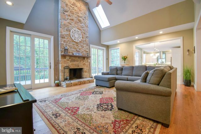 a living room with furniture fireplace and window
