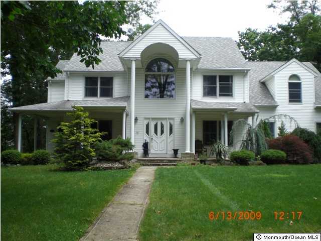 110 Freehold Road Manalapan, NJ 07726 - Photo 1 of 3 a front view of a house with a yard