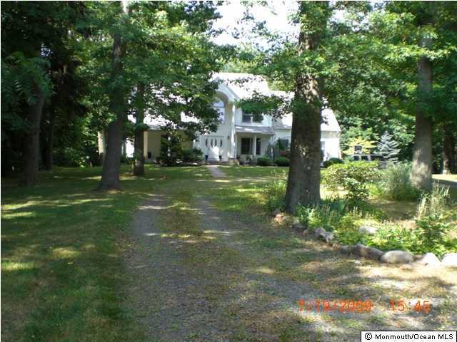 110 Freehold Road Manalapan, NJ 07726 - Photo 2 of 3 a backyard of a house with lots of green space and fountain