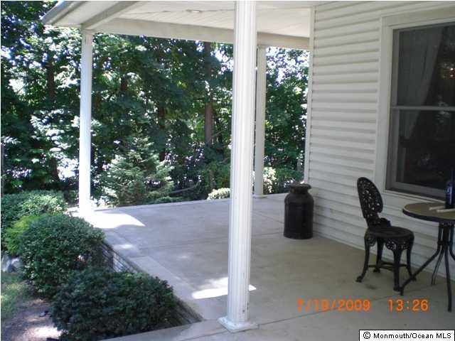110 Freehold Road Manalapan, NJ 07726 - Photo 3 of 3 a view of a patio with table and chairs and potted plants