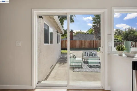 a backyard of a house with table and chairs