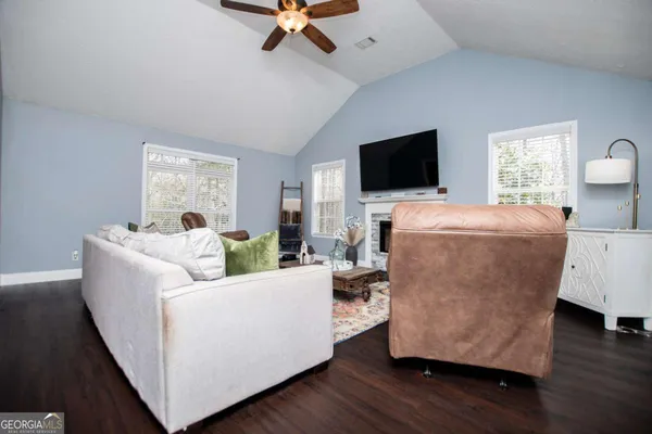 a living room with furniture and a flat screen tv