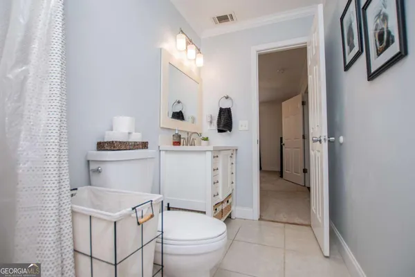 a bathroom with a toilet sink and shower