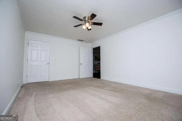 a view of an empty room with a ceiling fan