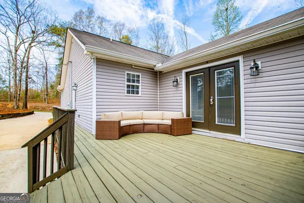 a view of a house with wooden deck