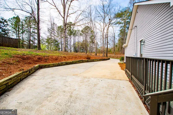 a view of a yard with wooden fence