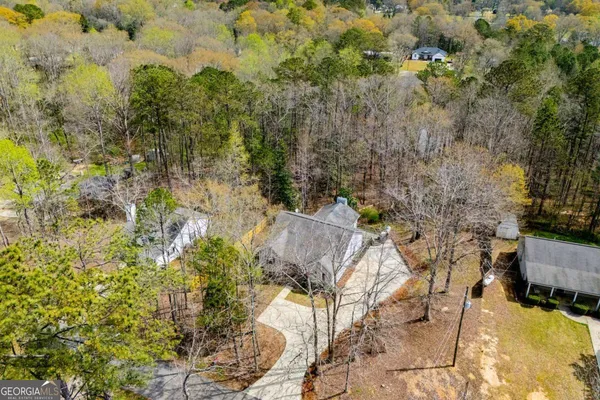 an aerial view of a swimming pool with outdoor seating