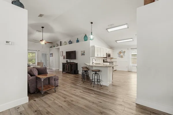 a view of kitchen with furniture and wooden floor