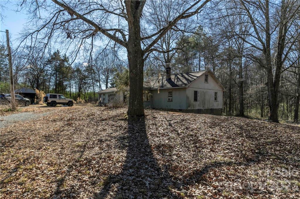 7607 Tesh Road Monroe, NC 28110 - Photo 19 of 31 a tree in front of a white house