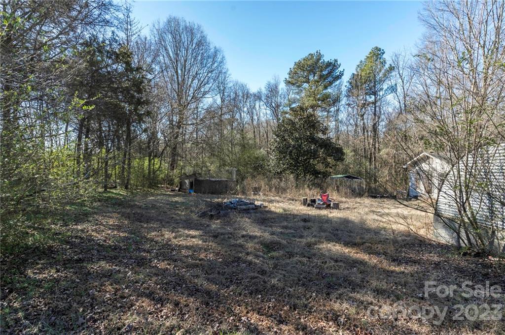 7607 Tesh Road Monroe, NC 28110 - Photo 20 of 31 a view of a forest with trees in the background