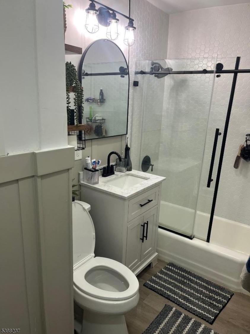 744 Hazard Place, Unit 1F Elizabeth, NJ 07208 - Photo 12 of 12 a bathroom with a sink a toilet a mirror and shower