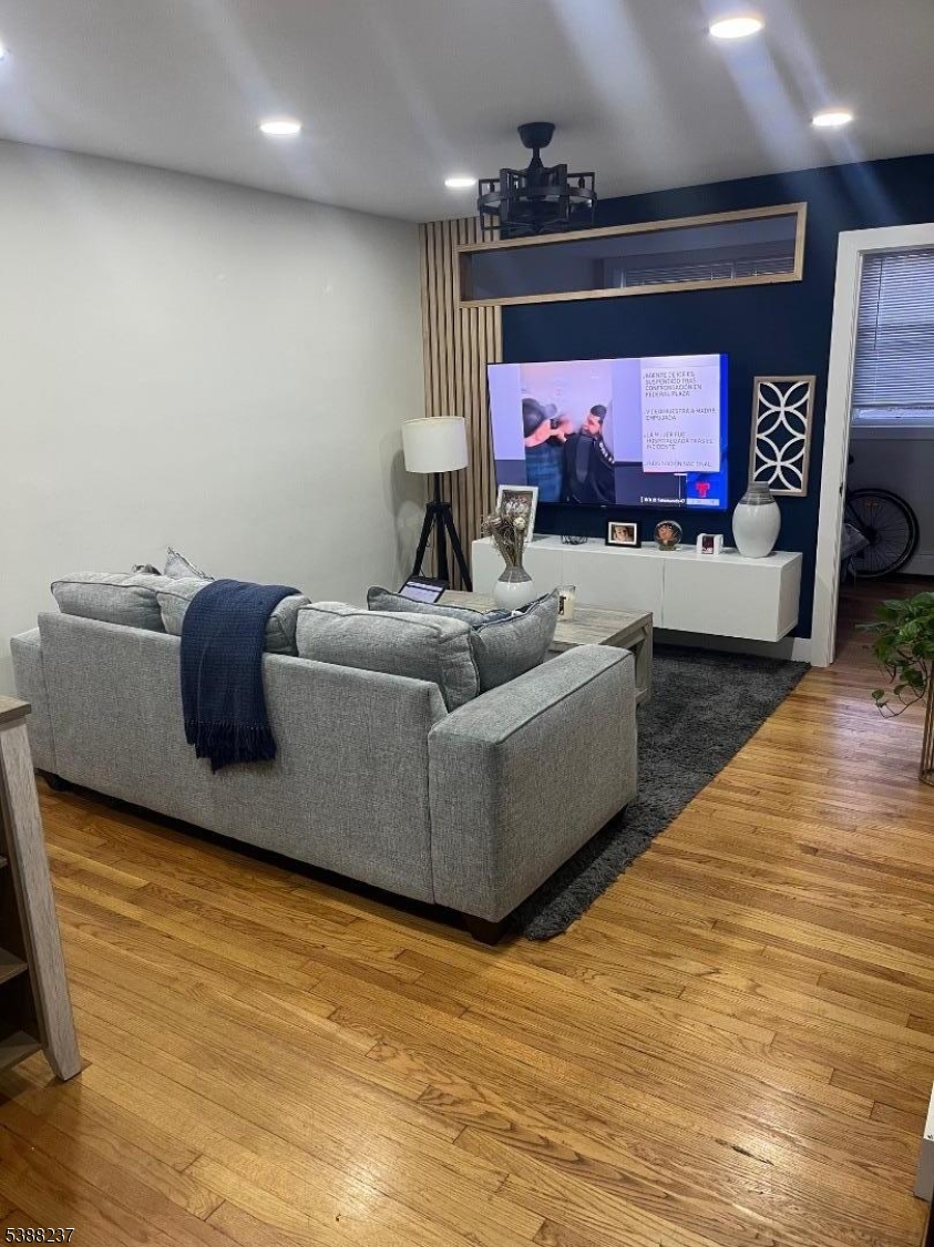 744 Hazard Place, Unit 1F Elizabeth, NJ 07208 - Photo 2 of 12 a living room with furniture and a flat screen tv