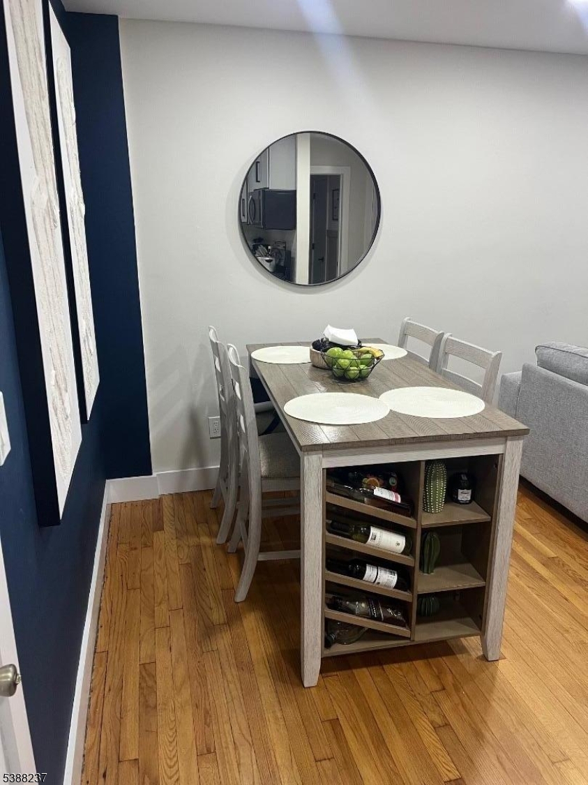 744 Hazard Place, Unit 1F Elizabeth, NJ 07208 - Photo 5 of 12 a view of a dining room with furniture and wooden floor