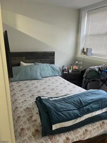 a bedroom with a bed and a mirror