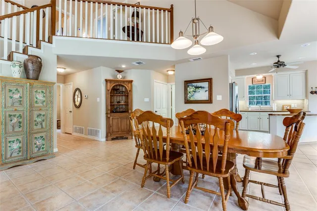 a view of a dining room with furniture and chandelier