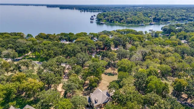 an aerial view of a houses with outdoor space and trees