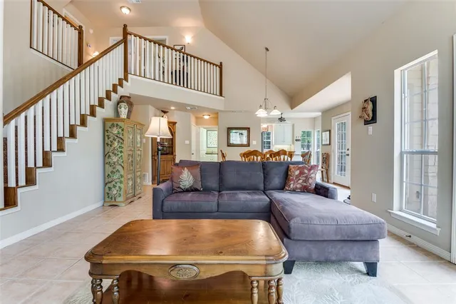 a living room with furniture and a dining table