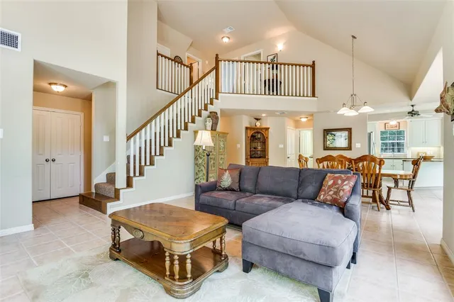 a living room with furniture ceiling fan and a rug