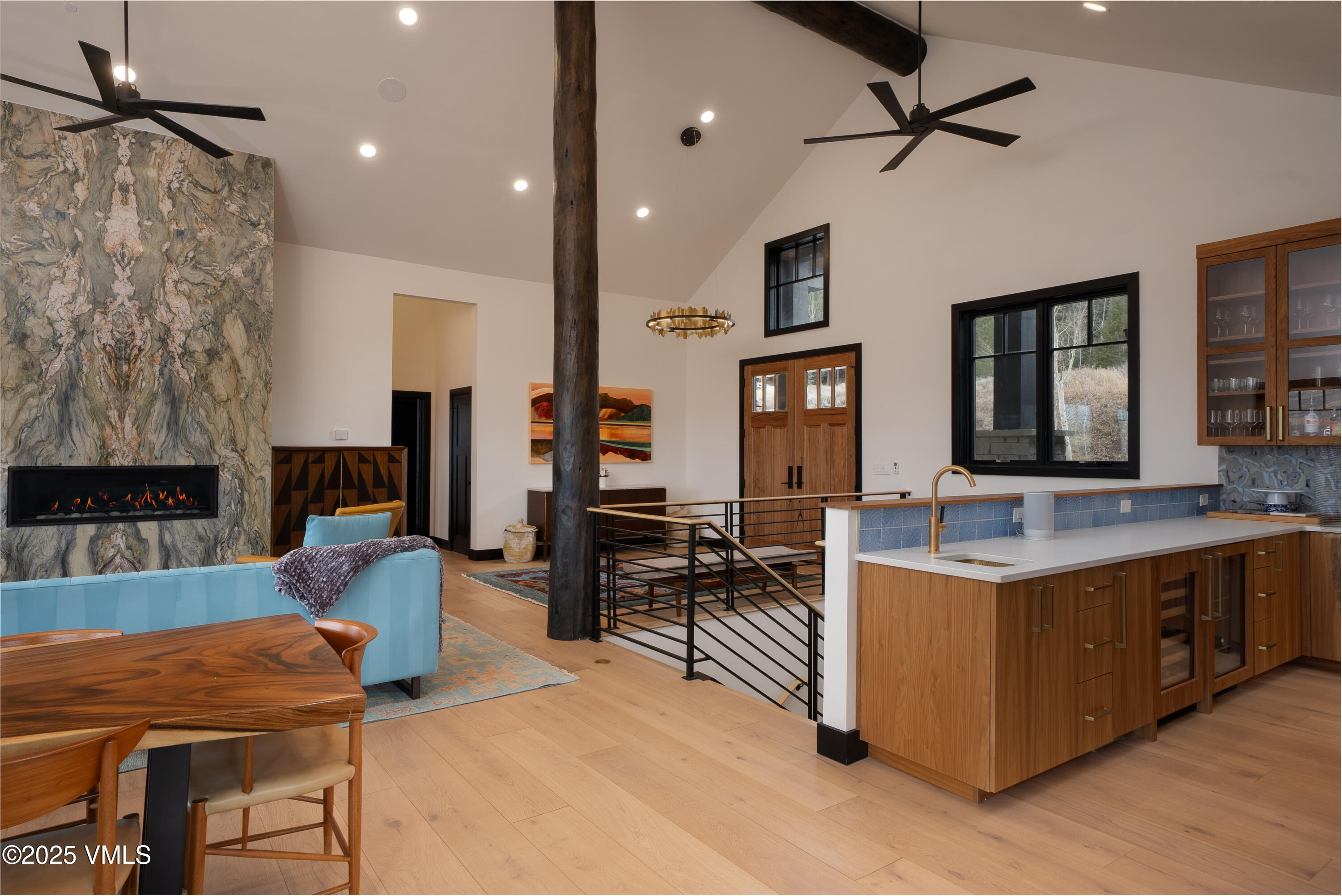 a living room with furniture a dining table and chairs with wooden floor