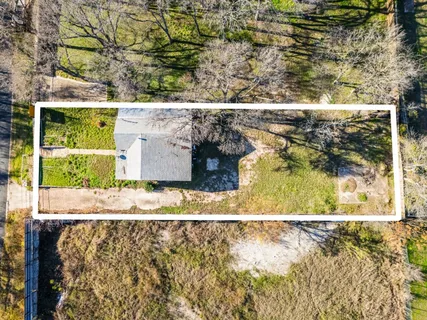a backyard of a building with large trees