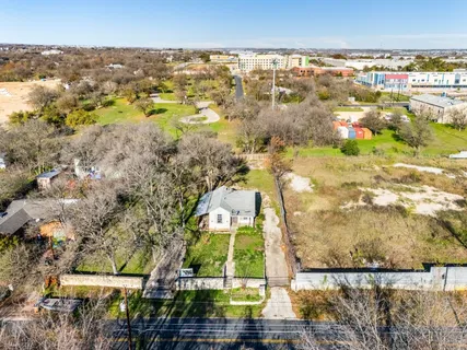 an aerial view of residential houses with outdoor space