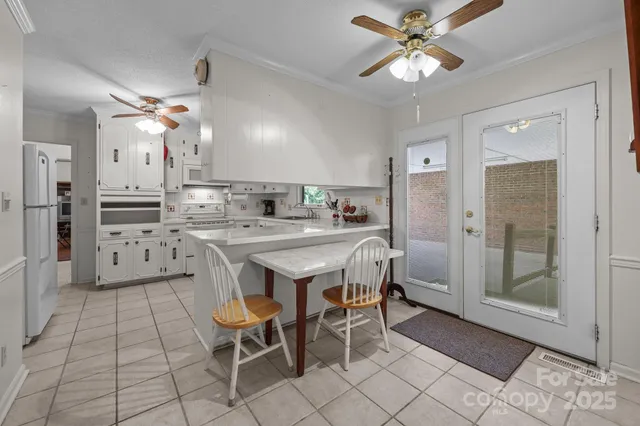 a kitchen with stainless steel appliances a sink cabinets and wooden floor