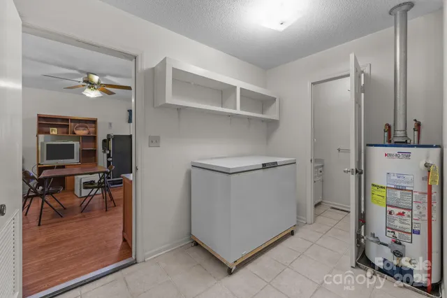 a room with furniture a wooden floor and a ceiling fan